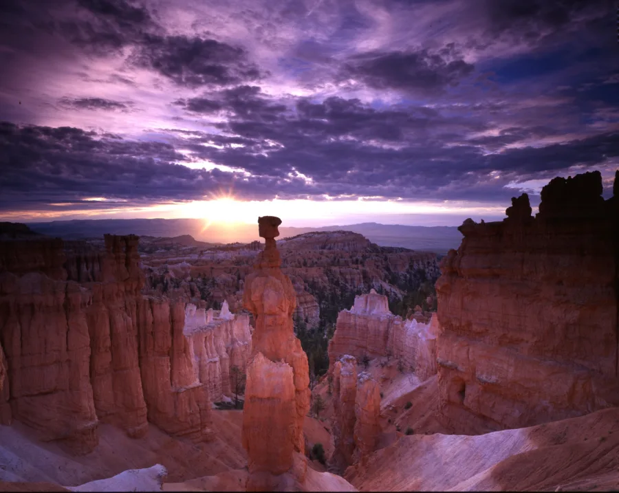 The orange stone pillar of Thor’s Hammer rises above the surrounding hoodoos in early light.